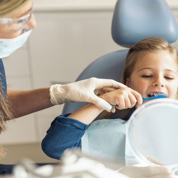 Child Learning How to Brush Teeth at Dental Office in Raleigh NC