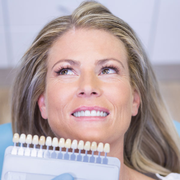 Attractive Senior Getting Evaluated for Veneers at a Dentists Offiice
