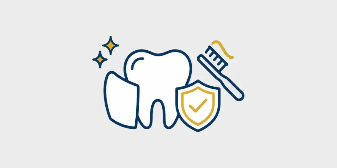 Navy and gold line icon of a veneer and tooth protected by a shield with a toothbrush on a light gray background
